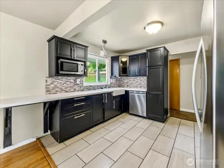 Updated kitchen with quartz counters, tile backsplash and stainless steel appliances. Separate dining area off the kitchen.