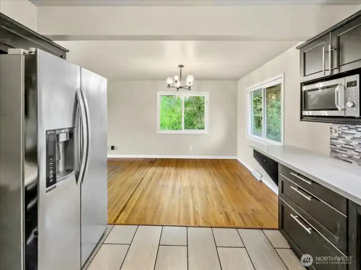 Updated kitchen with quartz counters, tile backsplash and stainless steel appliances. Separate dining area off the kitchen.