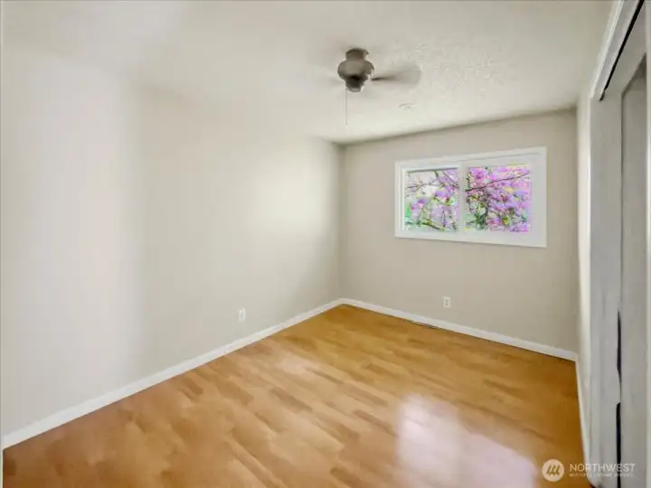 Second, private wing main floor bedroom with ceiling fan.