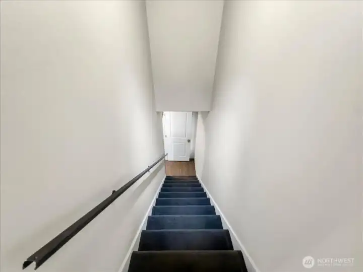 Interior access to your lower level with a separate entrance features a free-standing gas fireplace, a spacious laundry room with a utility sink, and direct access to the attached garage.