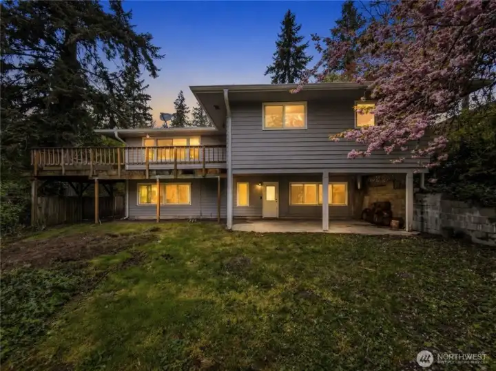 This secluded backyard is perfect for entertaining . The upper level offers a wrap around deck while the the ground level features a large covered patio that opens directly onto the spacious lawn. [virtually enhance]