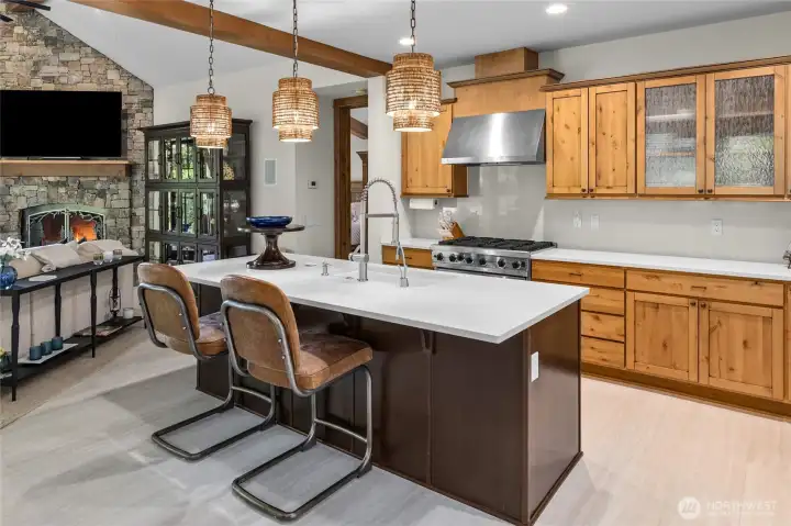 New island pendant and LED recessed lighting make the kitchen a bright, inviting space for cooking and gathering.