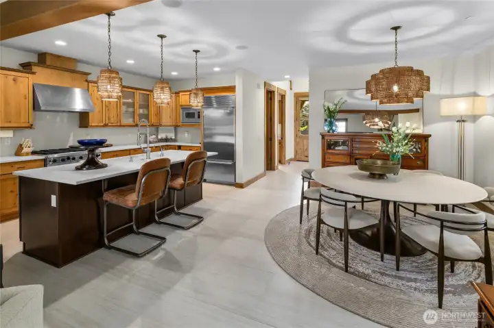 The chef's kitchen flows seamlessly into a separate dining space.