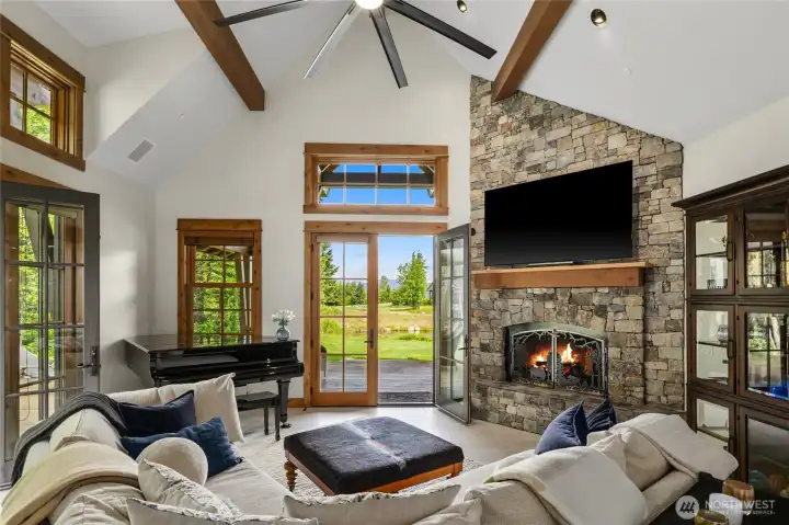 Unwind in the great room, framed by breathtaking views under vaulted ceilings and new ceiling fan.