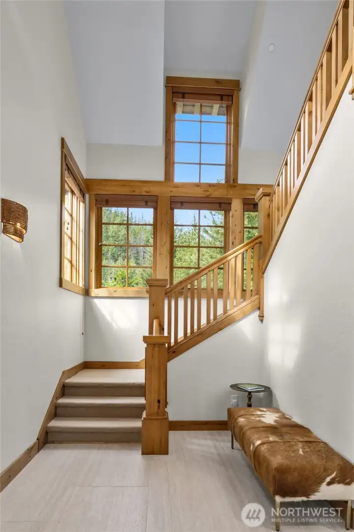 Light and bright staircase leading to two bedrooms with ensuites and a study nook.