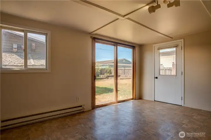 Sunroom looking out slider to fully fenced back yard