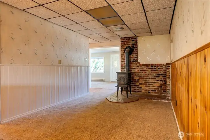 Dining room with cozy wood stove looking into living room