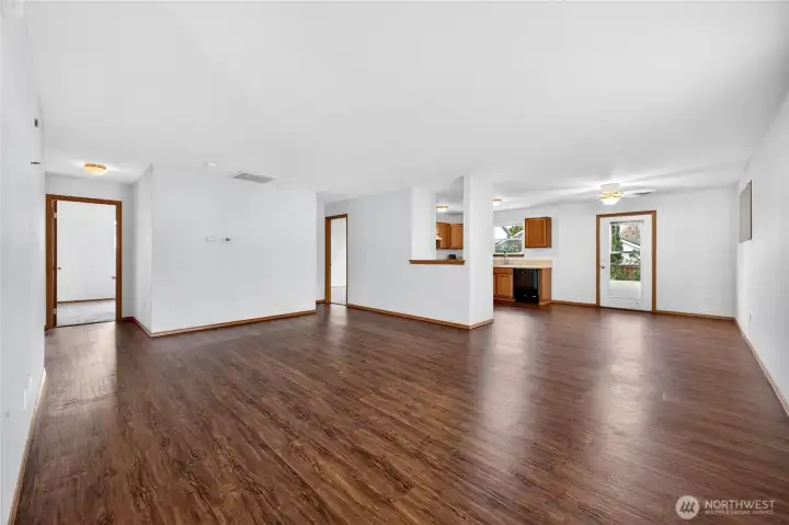 Additional view of the living room, dining room and kitchen.