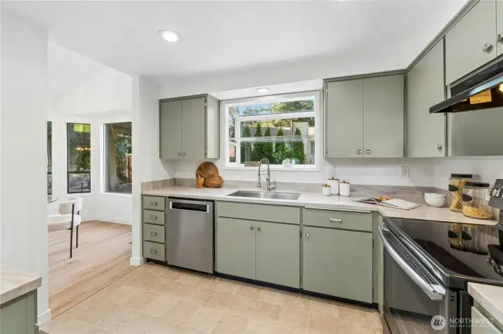 Efficient kitchen with stainless steel appliances, garden window overlooking the rear yard and lots of storage and prep space