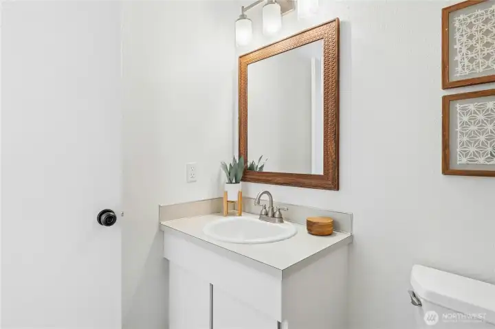 Lower-level half bathroom with laundry
