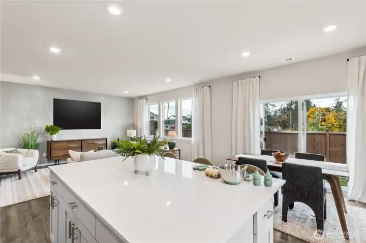 Large kitchen island with breakfast bar. **Photo is representational. Actual home is under construction. Colors, materials, and features may vary. See site agent for details.**