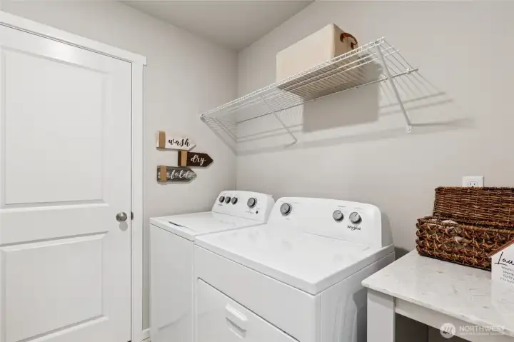 Dedicated laundry room with mechanical closet, and folding table. Photo is representational. Actual home is under construction. Colors, materials, and features may vary. See site agent for details.
