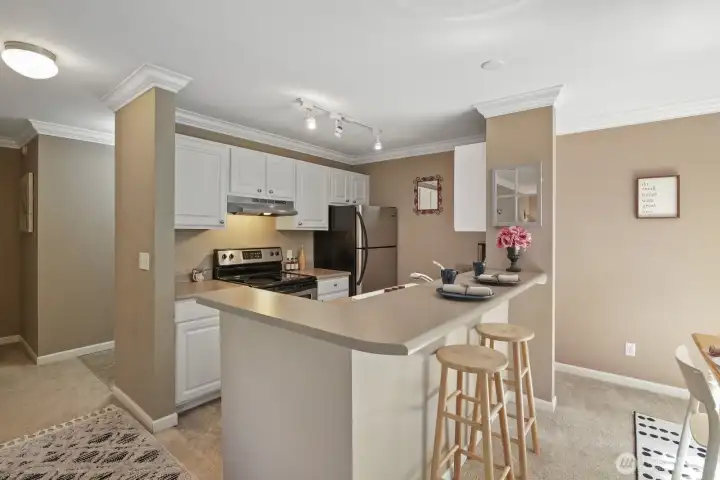 Solid stone countertops and convenient eat-in or serving bar in Kitchen