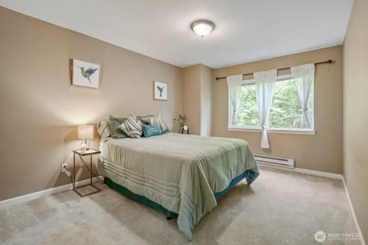 Primary bed overlooks front of unit- Maple tree outside offers good privacy.