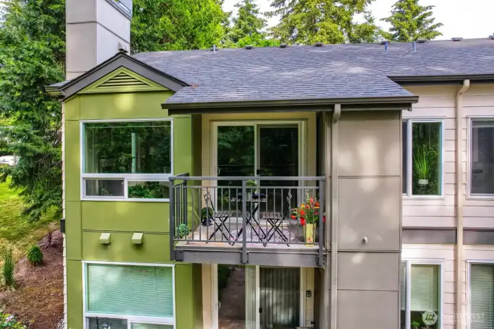 This photo pictures the updated roofs, Hardie plank siding, updated windows, new deck, updated railing and wrapped chimneys.  With the amazing greenbelt surround, you're sure to enjoy the covered deck any time of day!  The storage on deck also hosts the wrapped water heater