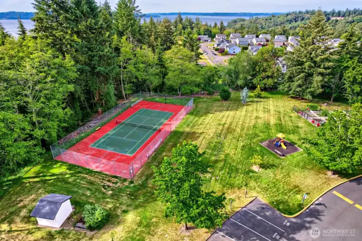 Aerial photo of surrounding neighborhood & the Sound in the distance.  Also pictured is the sport's court, playground and community garden.