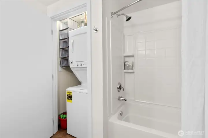 In-unit laundry with washer and dryer in full bath.