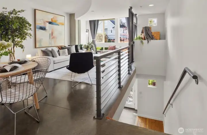 Stairs off living space to lower studio space