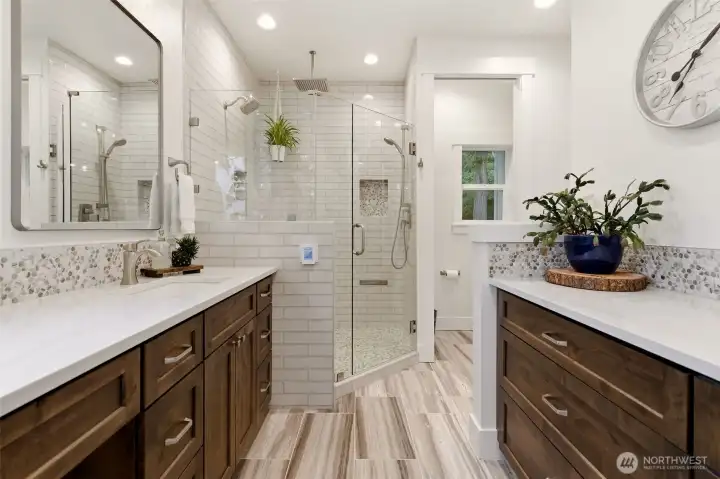 Primary spa inspired shower with multiple shower heads in the main home.