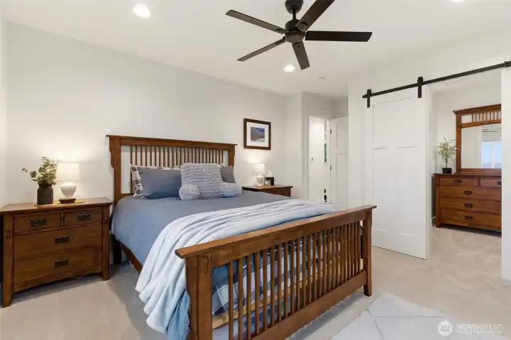 Another bedroom upstairs in the main house with walk in closet.