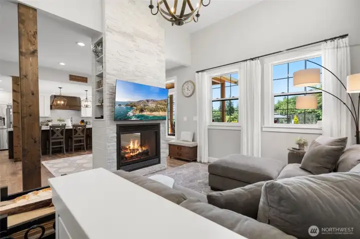 Living room in the second house with double sided gas fireplace.