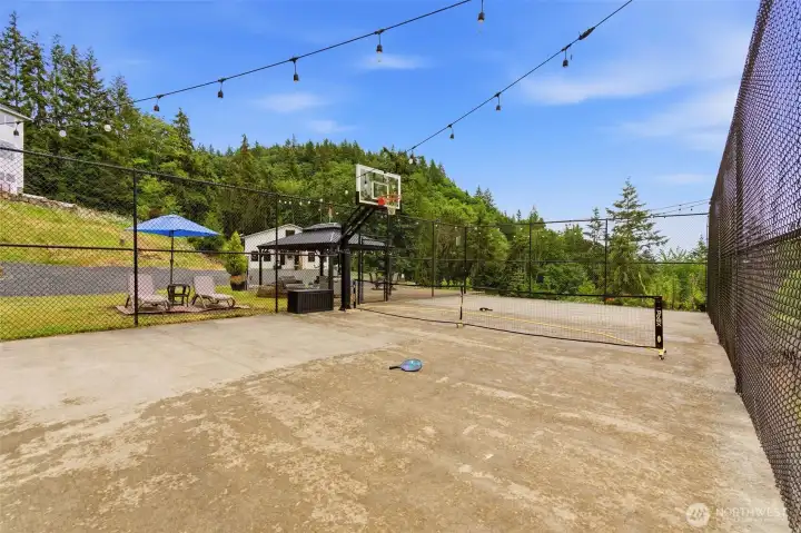 Sports court with covered patio, firepit and lounge area.