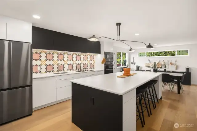 The fun kitchen is the heart, featuring a spacious entertaining island, top-of-the-line appliances and exquisite handcrafted tile from Mexico.