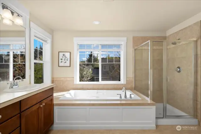 A separate shower area with elegant glass and tiling. The large soaking tub is a delight to relax after a long day.