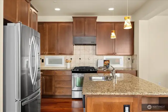 A Chef's Kitchen with sparkling stainless steel appliances, ample countertops and cabinets.