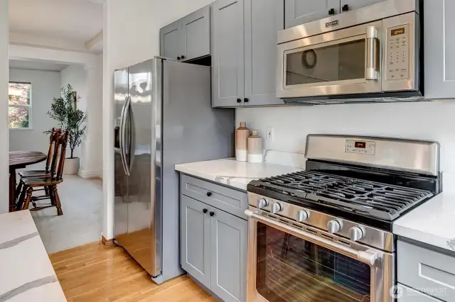 A 5-burner gas range, all newer stainless steel appliances.