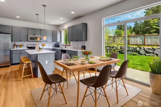 Sliding doors open to the expansive backyard deck, ideal for entertaining, while the fully fenced yard.