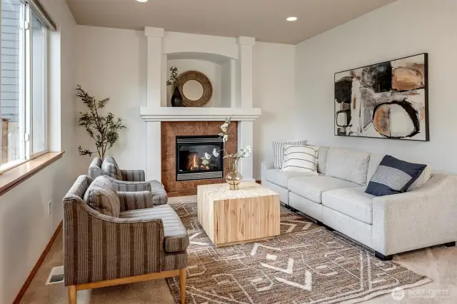 The open layout seamlessly connects to the nook area and family room, which includes a cozy gas fireplace.