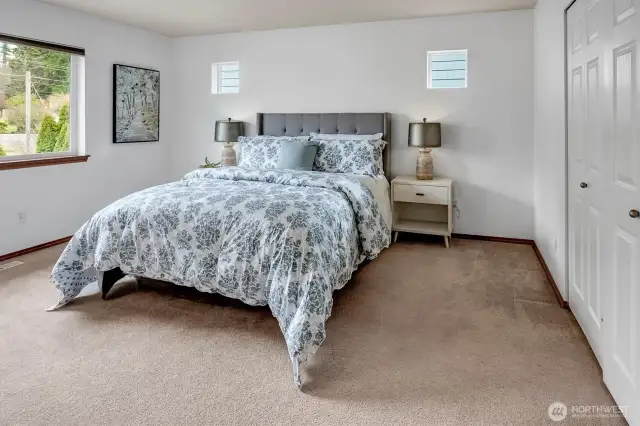 The primary suite boasts an en-suite bath with a double vanity and a deep soaking tub, and a large walk-in closet.