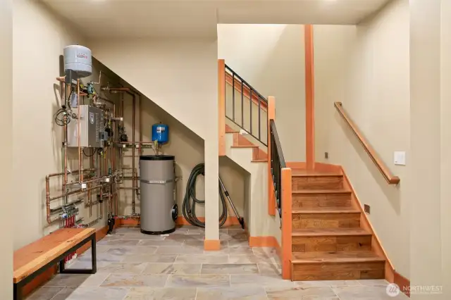 Opera lighted hardwood floor, custom built handrailed staircase leading to 2nd floor from garage and bunk area hallway.