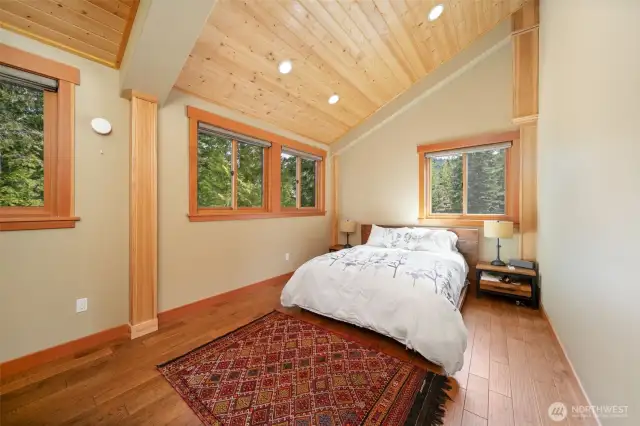 Primary bedroom off kitchen is very roomy and ample windows let the sun shine in.