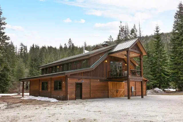 Main floor is home to livestock stalls, huge covered garage and full length bunk house with adjoining bath/laundry.