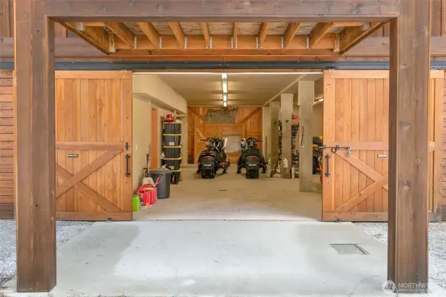 Front sliding barn door style 8X10 garage door opens up to over 1100sqft of covered, heated space for your coveted toys.