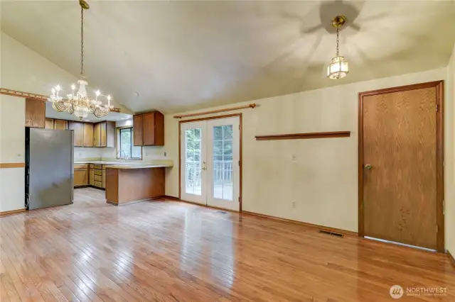 Spacious dining and kitchen area and the door to the right leads to the lower level.