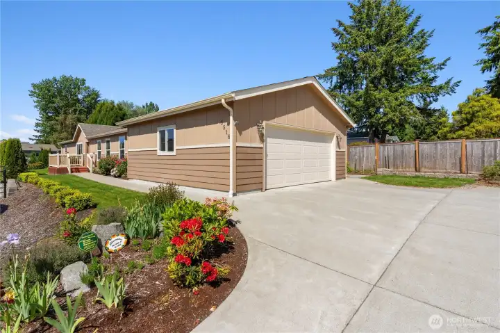 This beautifully maintained exterior features lush landscaping, a spacious driveway, and a two-car garage—offering curb appeal and convenience in the heart of a 55+ community. Solar panels and Energy Star certification ensure lasting value.
