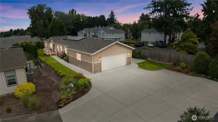 Large back patio off garage by vines and berries to enjoy Spring, summer and fall on!