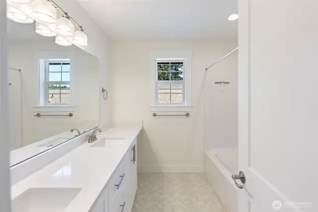 The upstairs hall bath with double vanities.