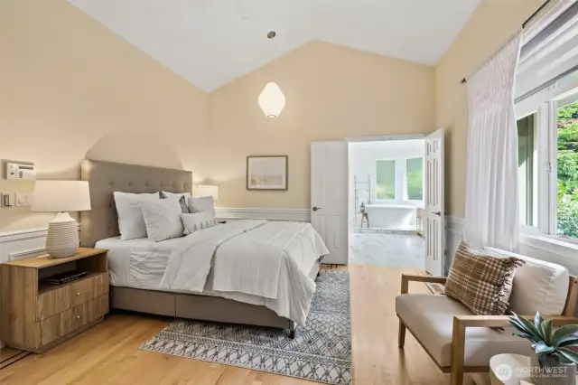 Primary bedroom with vaulted ceilings, En-suite bath and walk-in closet.