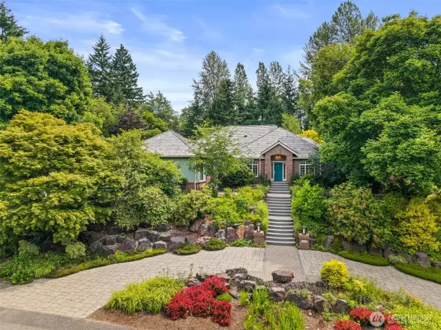 Don't you just love a circular drive!  This home is perched above the street and sits on a flat 1.4 acre lot.  A rare opportunity for single level living in a fantastic neighborhood!  Avoid the stairs by parking next to the garage on the left side of the home.