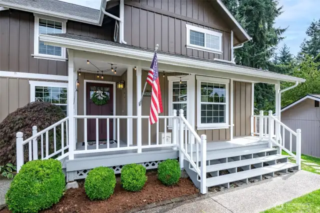 Inviting covered front porch spanning the front of the home