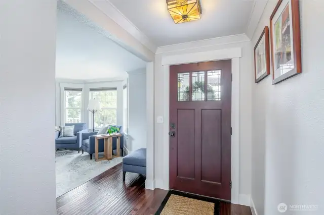 Traditional stained glass light fixture and hardwoods welcome