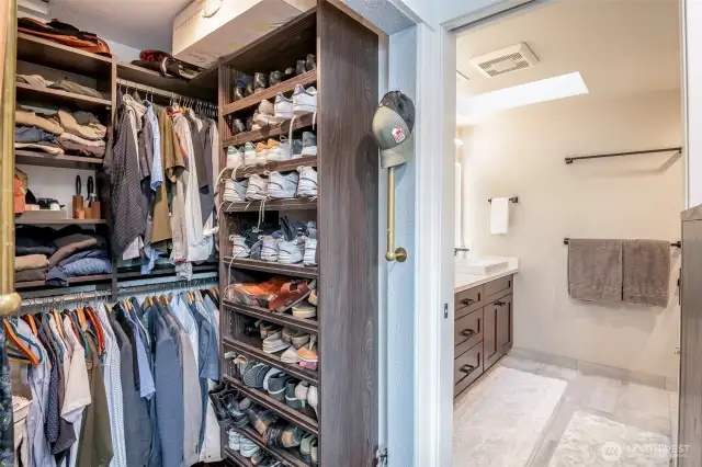Custom walk-in closet system located right outside the primary bathroom