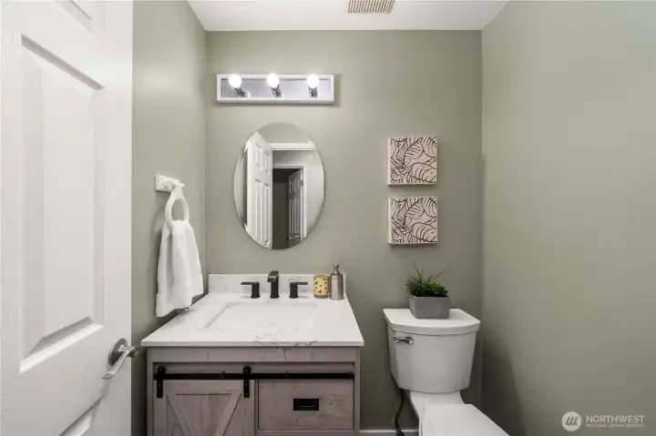 This remodeled half bath is off the entry on the main floor.