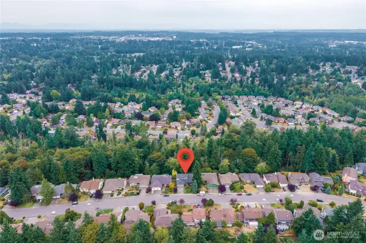 This aerial photo shows the stunning greenbelt behind this lovely neighborhood.