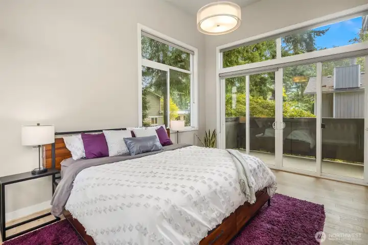 A spacious primary suite with a private deck