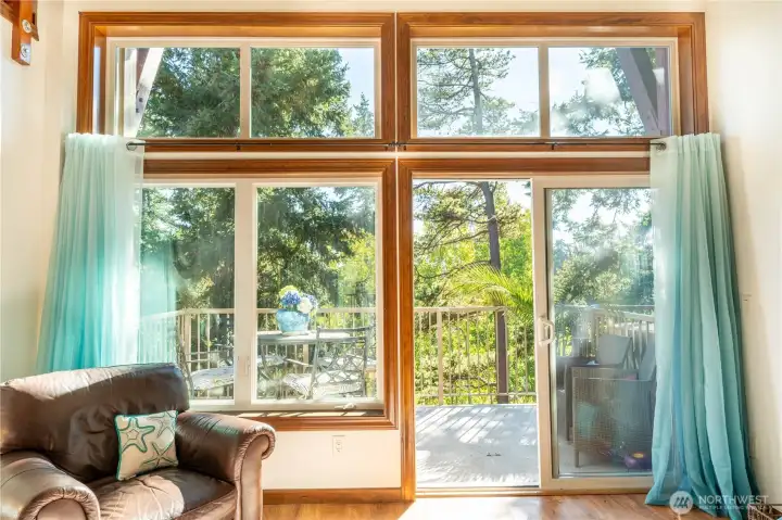 Sliders lead to the back deck with filtered sunlight.